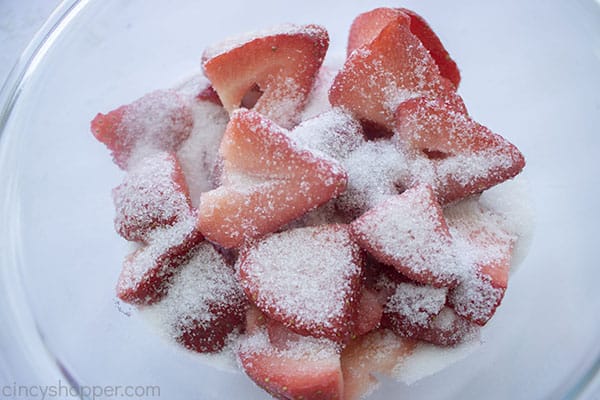 Sugar added to strawberrie sin a bowl