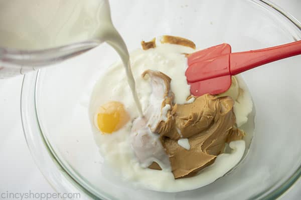 Adding milk to peanut butter mixture