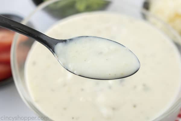 Spoon with white sauce for pizza