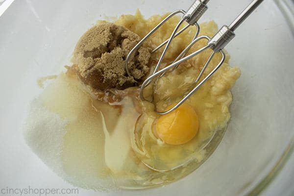 Banana, egg, vanilla, and sugars added to bowl