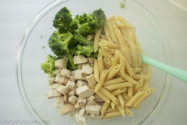 Pasta, chicken, and broccoli added to alfredo mixture