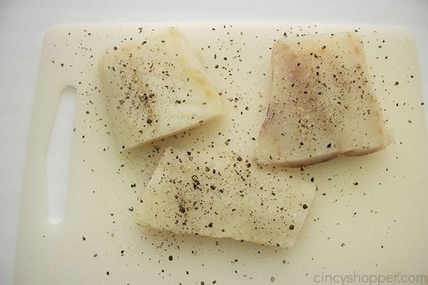 Fish fillets on a board with salt and pepper