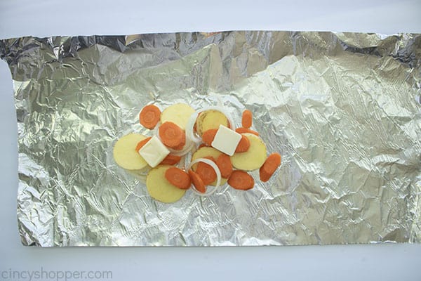 Carrots, Potatoes, Onions, and butter added to foil