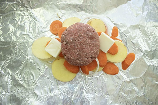 Hamburger patty added to top of vegetables