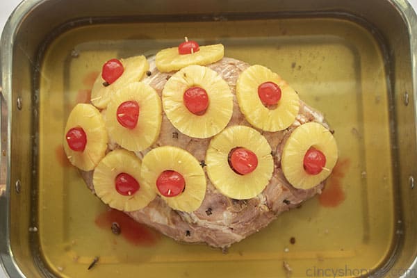 Glazed ham with pineapple in a pan