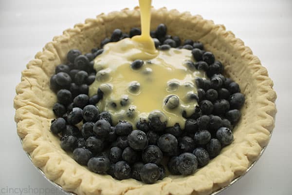 Custard added to blueberries in pie shell