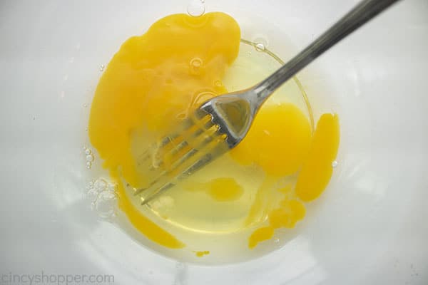 Eggs with fork in a bowl