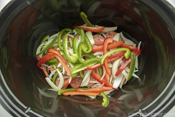 Peppers and onions added to crockpot