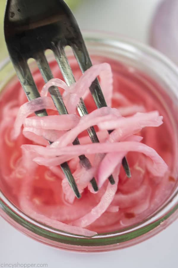 Pickled onions on a fork