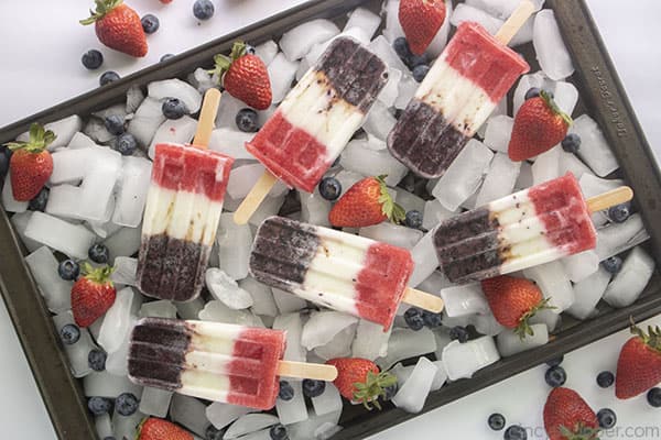 Fourth of July popsicles on a sheet pan and ice