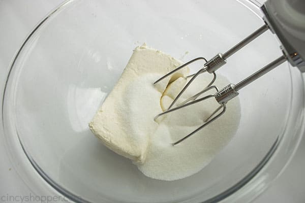 Cream cheese and sugar in bowl