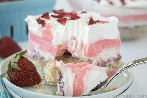 Strawberry Cheesecake layered dessert on a fork