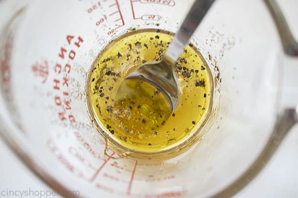 Watermelon salad dressing in a measuring cup