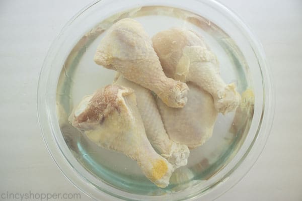 Chicken legs brining in water