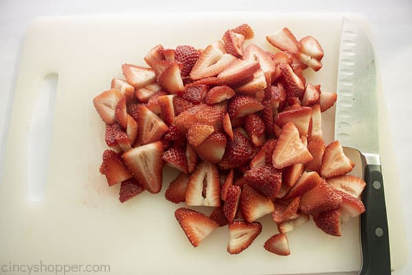 Sliced strawberries on a cutting board