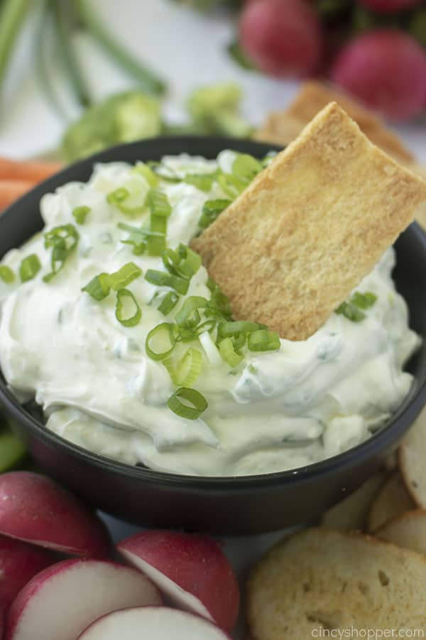 Pita chip dipping in homemade onion chip dip