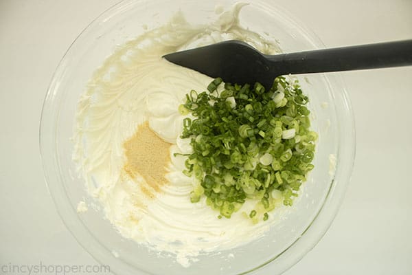 Garlic and green onions added to sour cream and cream cheese