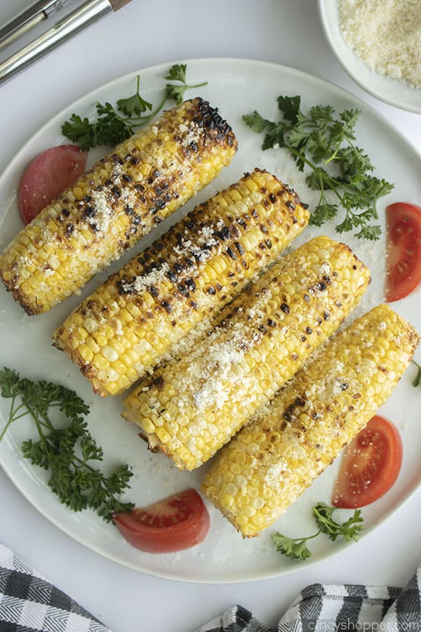 Parmesan Grilled Corn on the cob with garlic on a plate