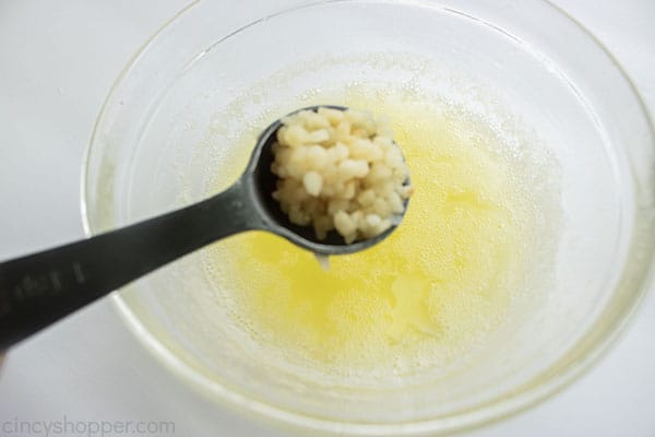 Adding garlic to melted butter