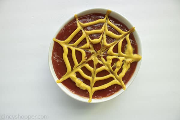 Mustard on ketchup for spider web