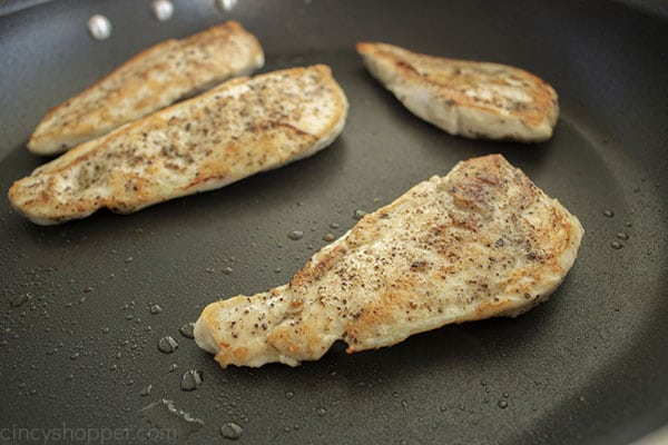 grilling chicken breasts in a pan