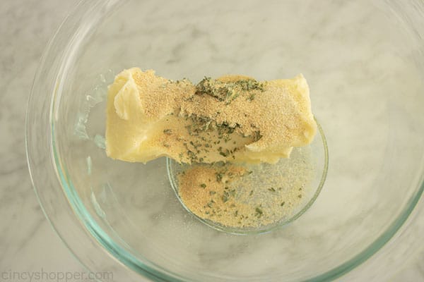 Butter, garlic, onion and parsley in a bowl