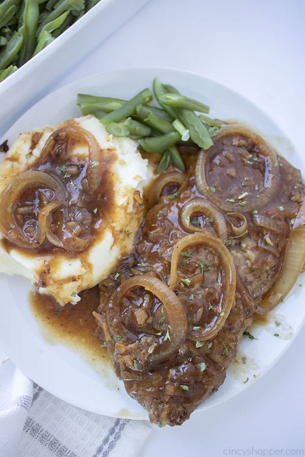 Cube Steak with onions and gravy on a plate
