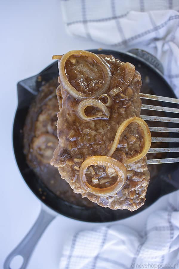 Cube Steaks with onions on a spatula 