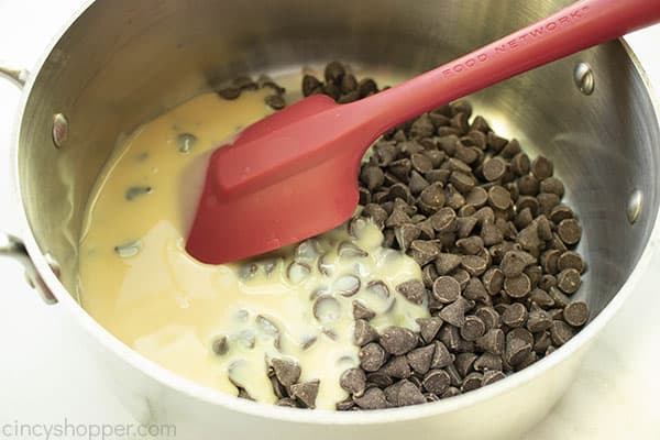 Chocolate Chips with sweetened condensed milk in a pan
