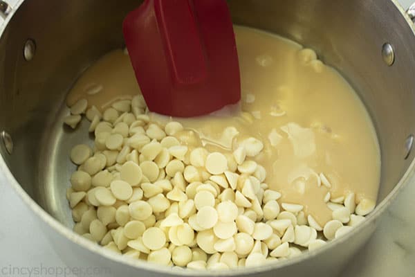 White chips in pan with sweetened condensed milk