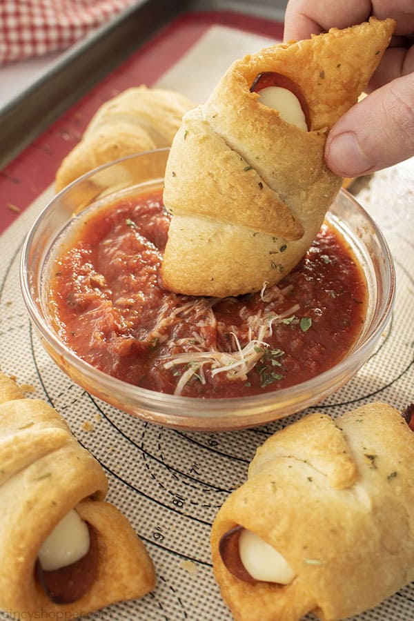 Cheesy Crescent Rolls with pepperoni dipping in sauce