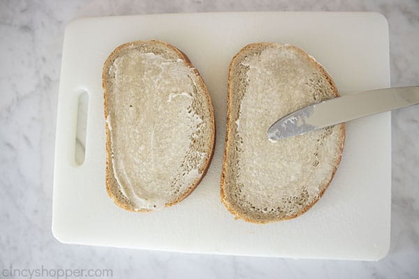adding butter to rye bread