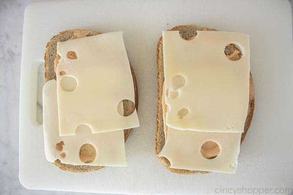 Adding Swiss cheese to bread