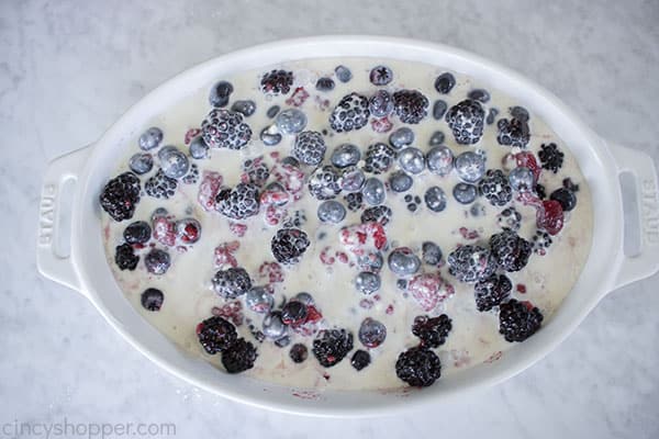 Cobbler mixture poured over berries