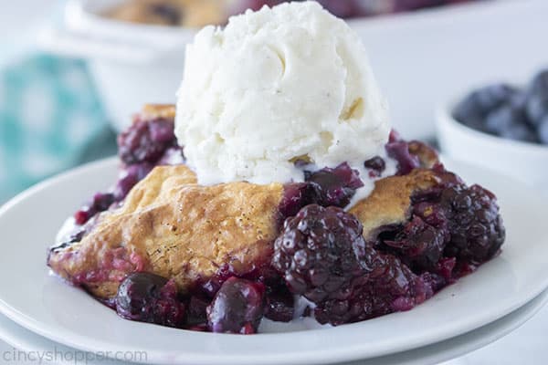 Baked mixed berry cobbler with ice cream on a plate