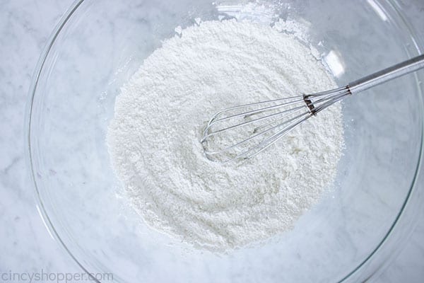 Dry ingredients for cobbler topping in a bowl with whisk 