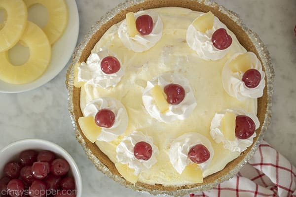 Whipped topping, pineapples chunks and cherries added to no bake pineapple pie