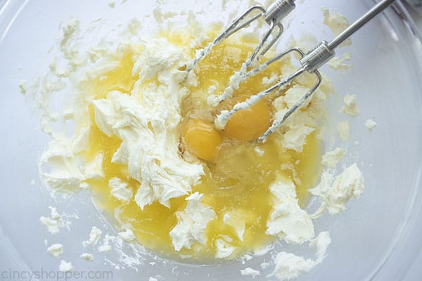 Cream cheese, eggs and butter in a bowl