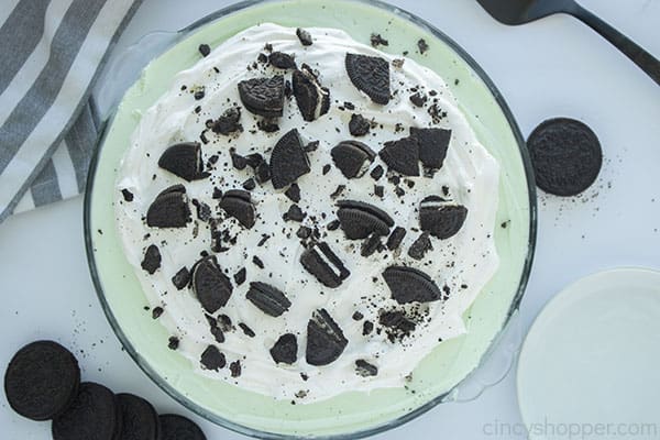 Whipped topping and crushed Oreo Cookies added to top of Grasshopper Pie