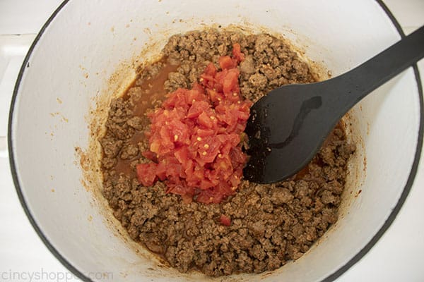 Tomatoes added to ground beef mixture