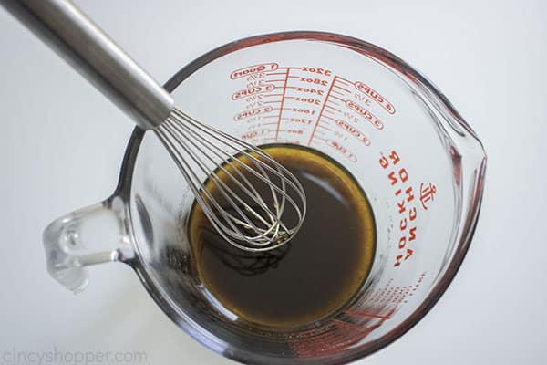 Balsamic dressing in a measuring cup