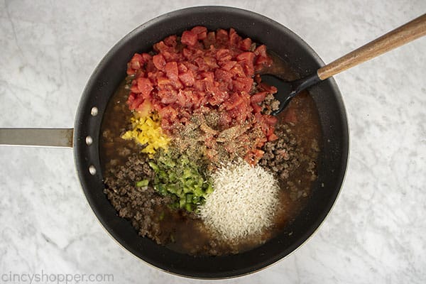 Tomatoes, broth, rice and spices added to ground beef