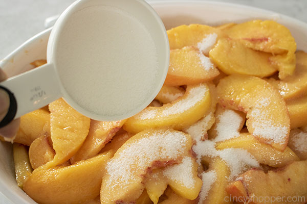 Adding sugar to fresh peaches