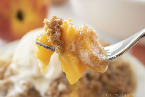 Fresh peach crisp on a fork