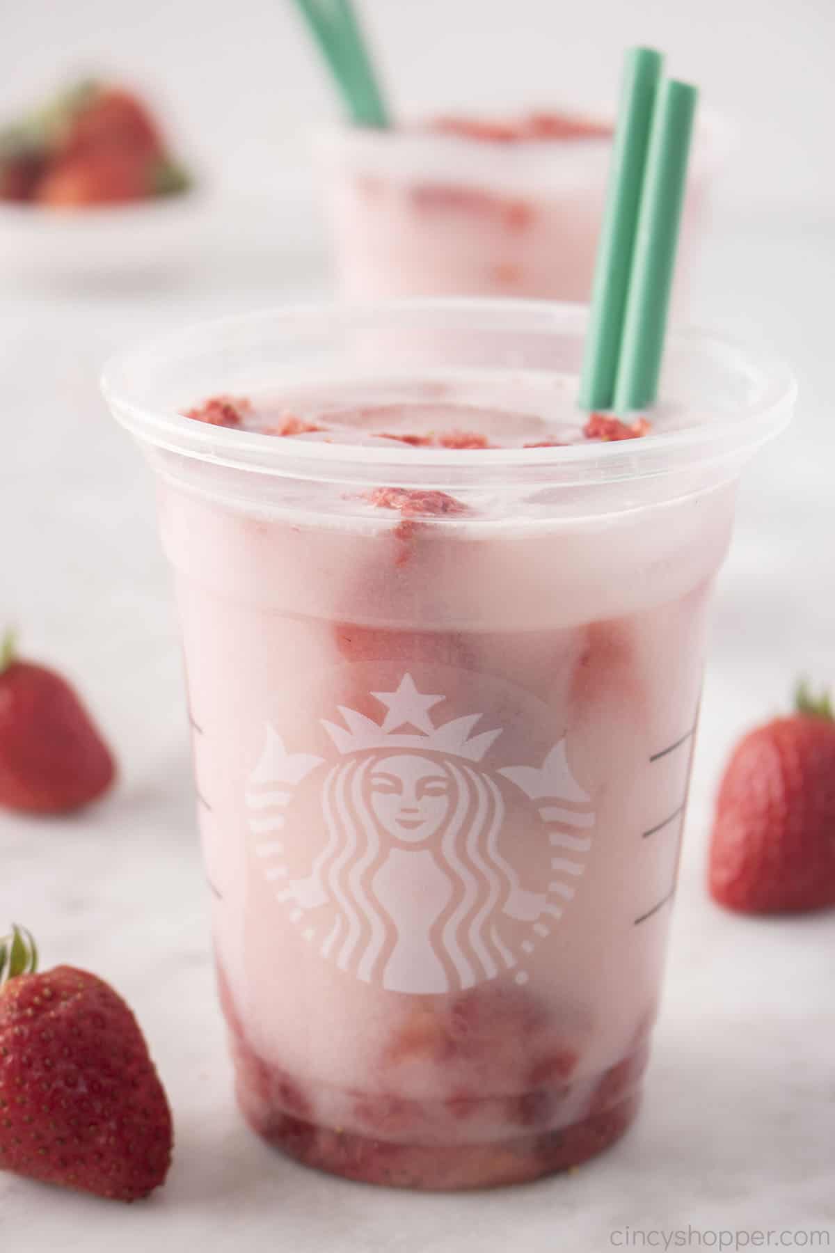 Starbucks Pink Drink in a cup with straws.
