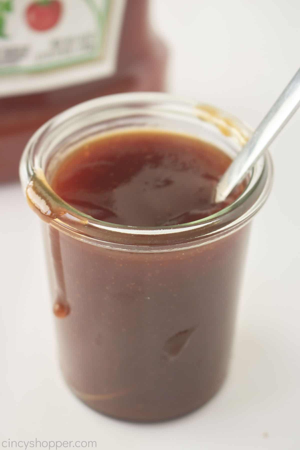 3 Ingredient BBQ Sauce in a jar with spoon.