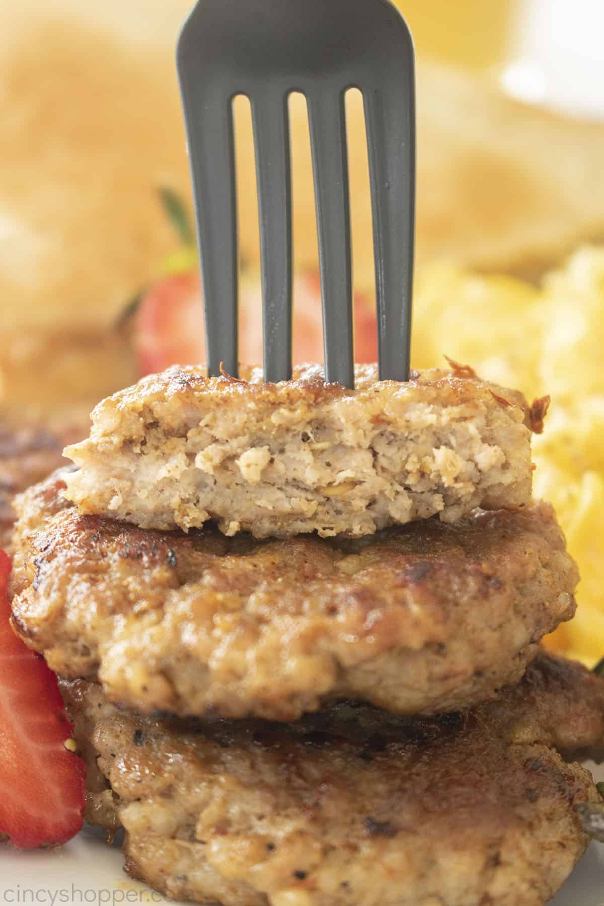 Stack of Breakfast Sausage Patties with a fork.