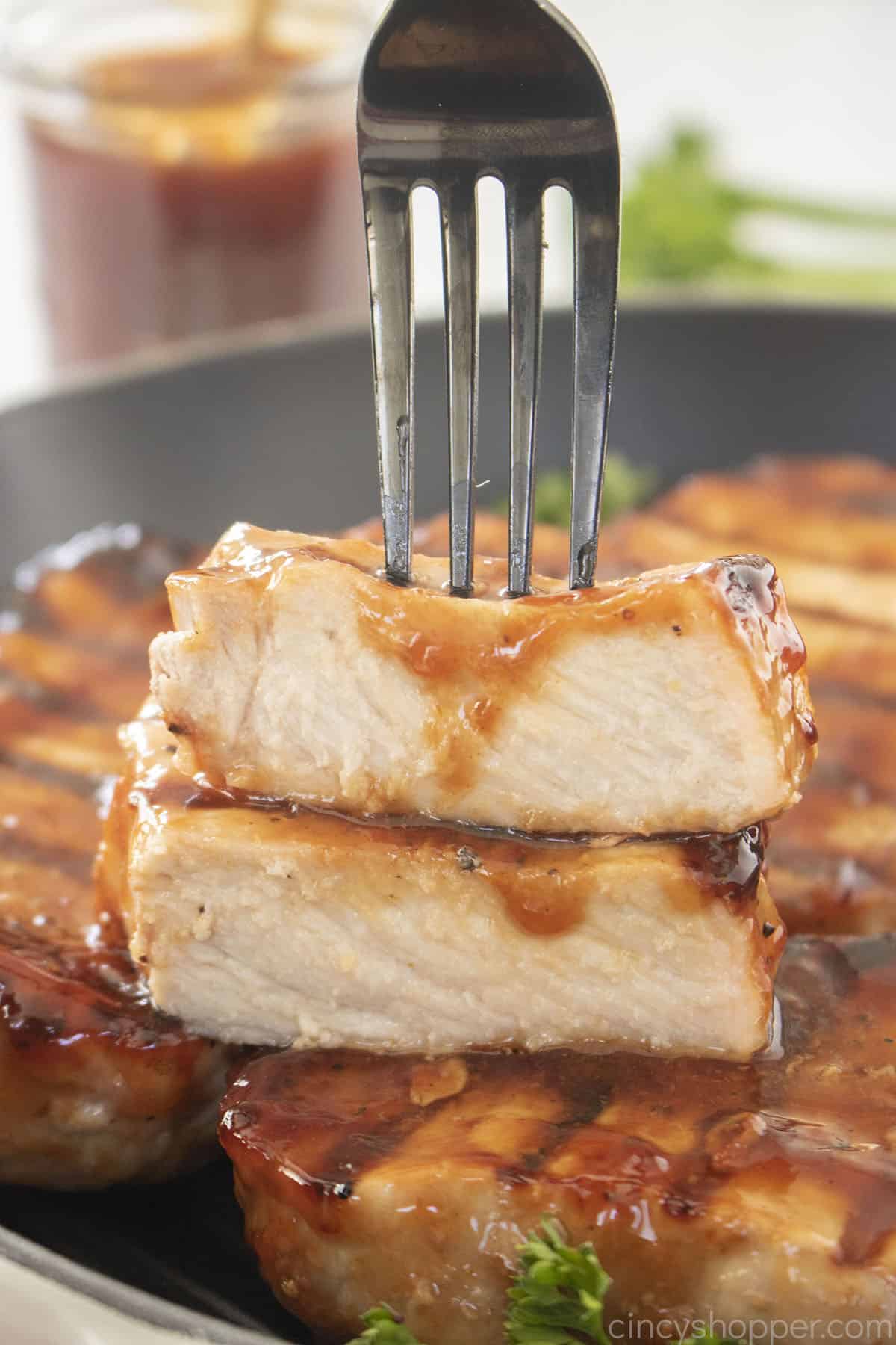 BBQ Pork Chop pieces on a fork.