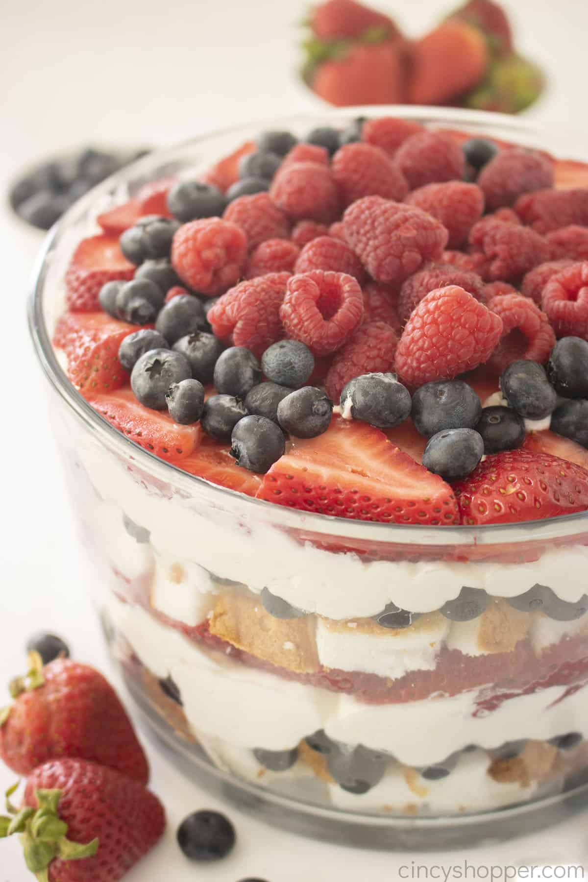 Berry Trifle with strawberries, blueberries and raspberries in clear dish.