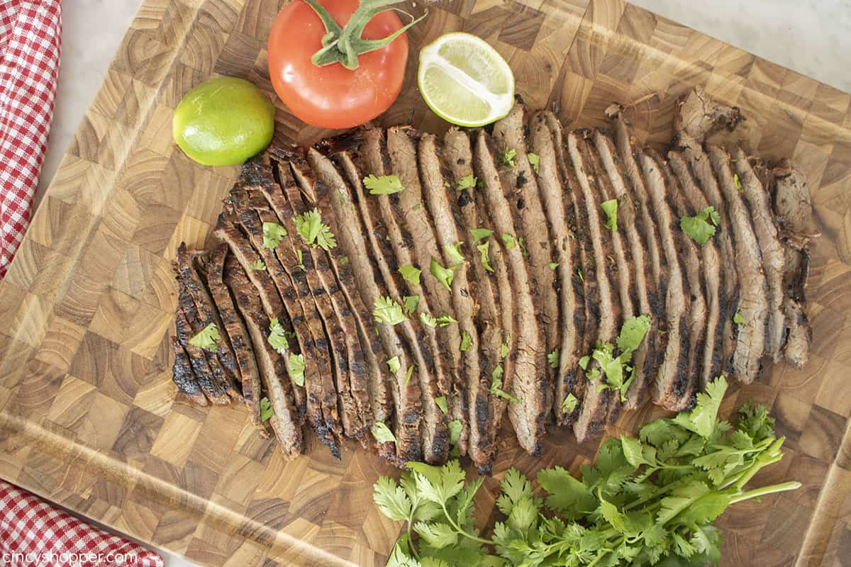 Grilled flank steak on a cutting board.